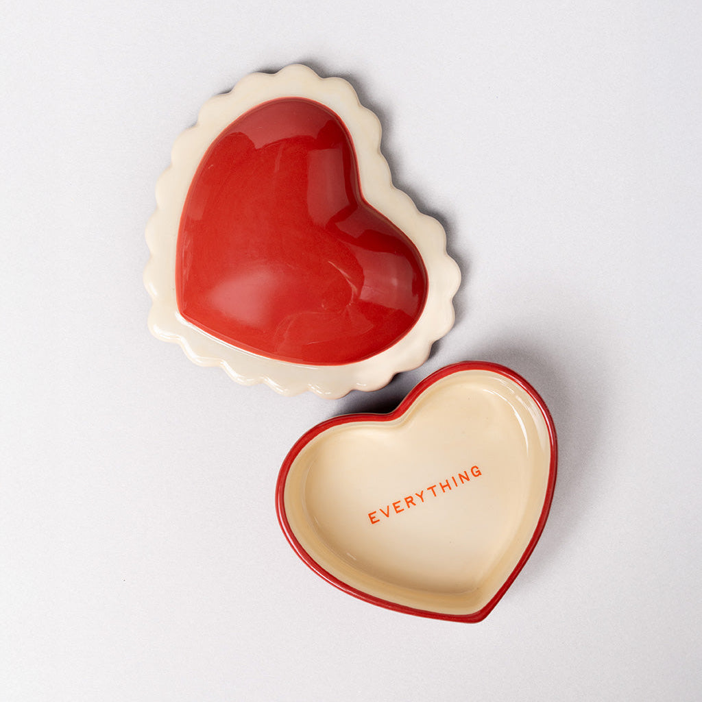 Heart-shaped ceramic dish with red interior and beige exterior, featuring the word 'EVERYTHING'.