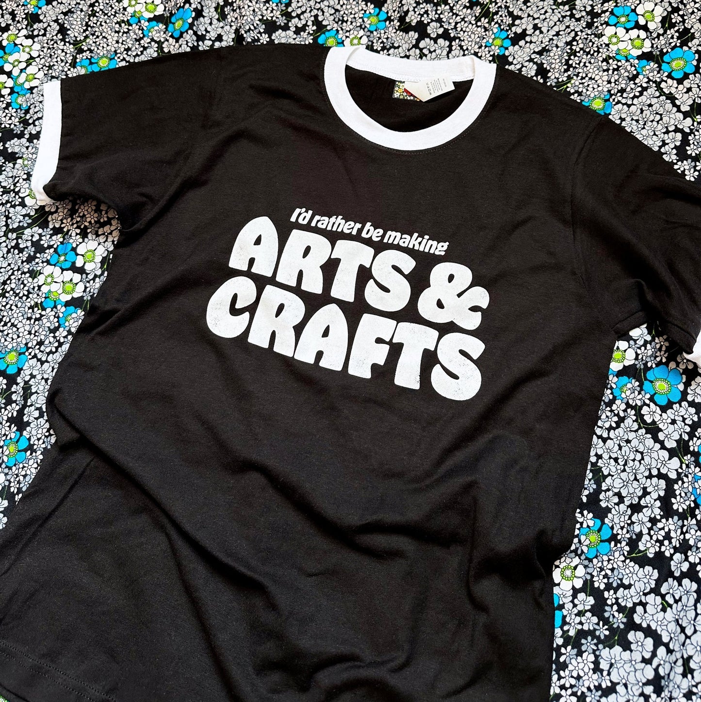 Black t-shirt with 'I'd rather be making ARTS & CRAFTS' text on a floral background