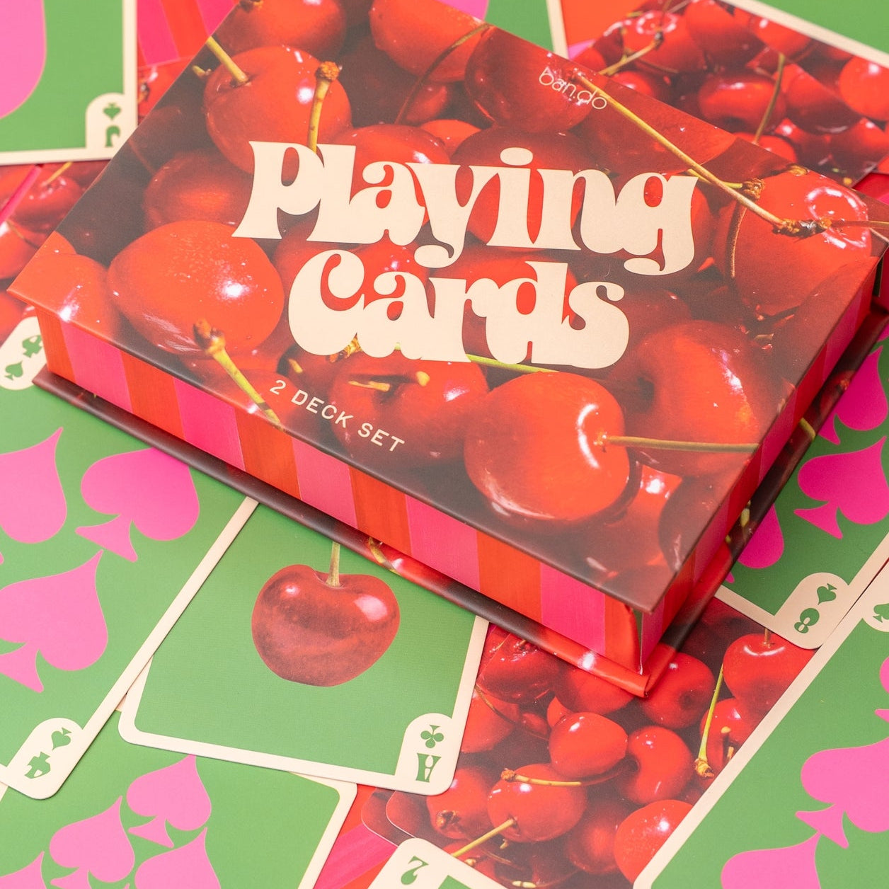 Playing card set with cherry design on a colorful background