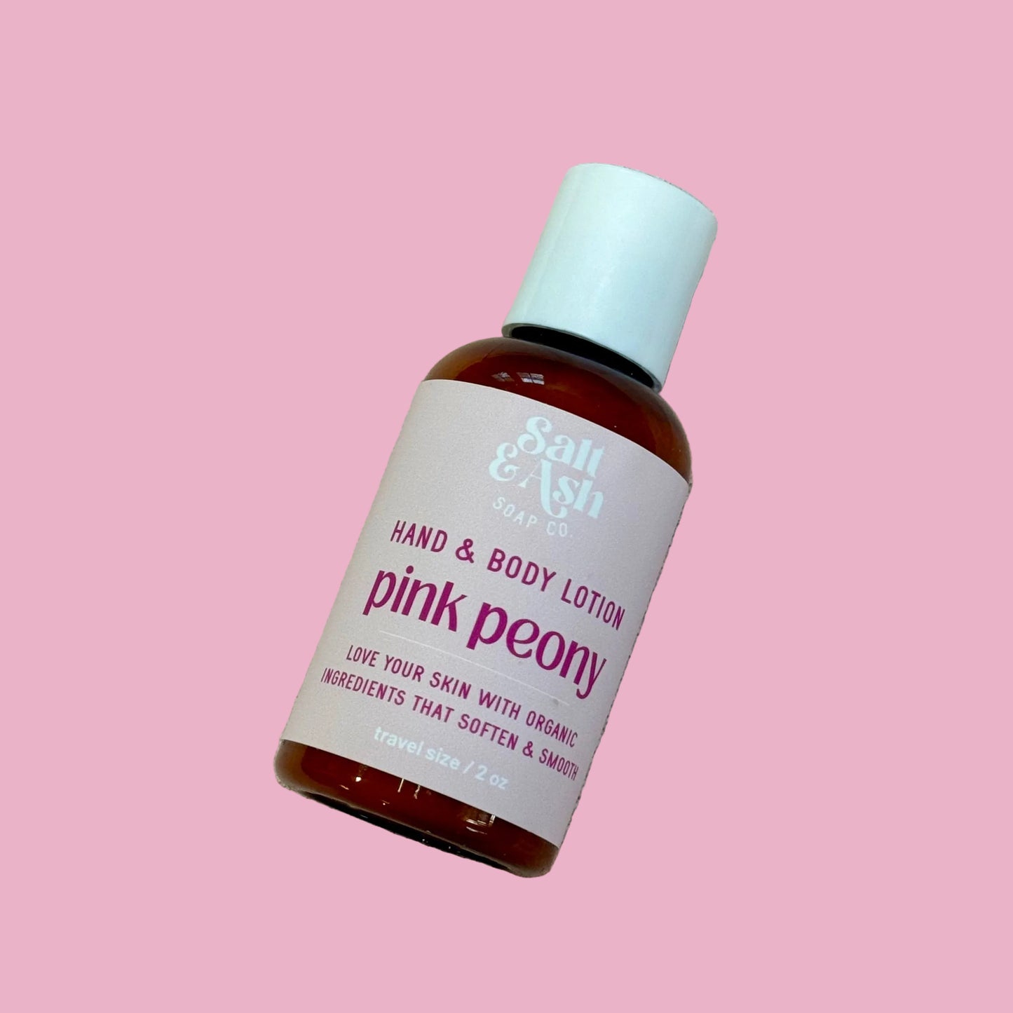 Bottle of 'Pink Peony' hand and body lotion on a light pink background