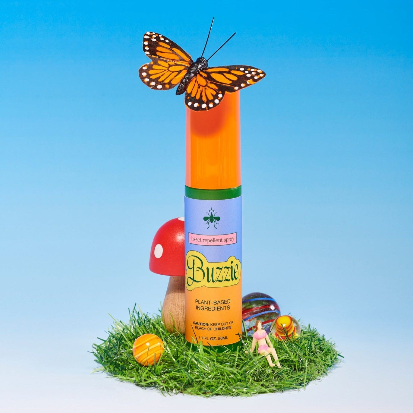 Buzzin' plant insecticide spray with a butterfly on top against a blue sky background